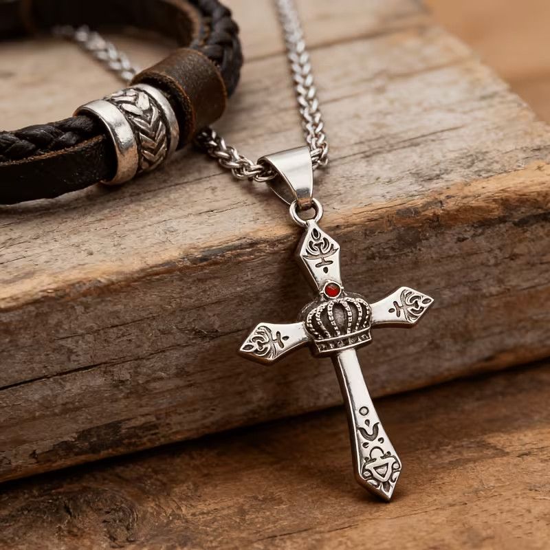 Man wearing vintage stainless steel crown cross pendant necklace with white shirt