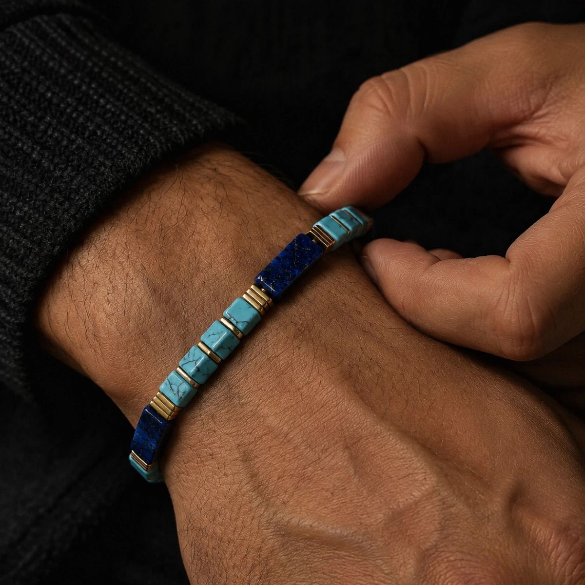 Close up view of hand adjusting Lapis Lazuli Bracelet