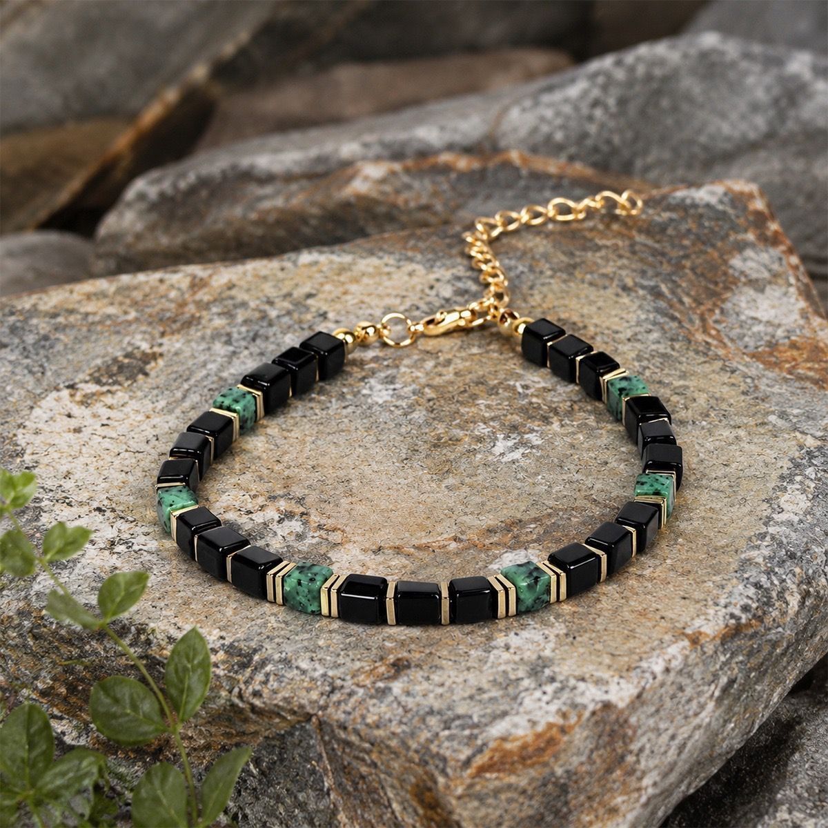 Obsidian Turquoise Bracelet resting on rugged grey rock texture