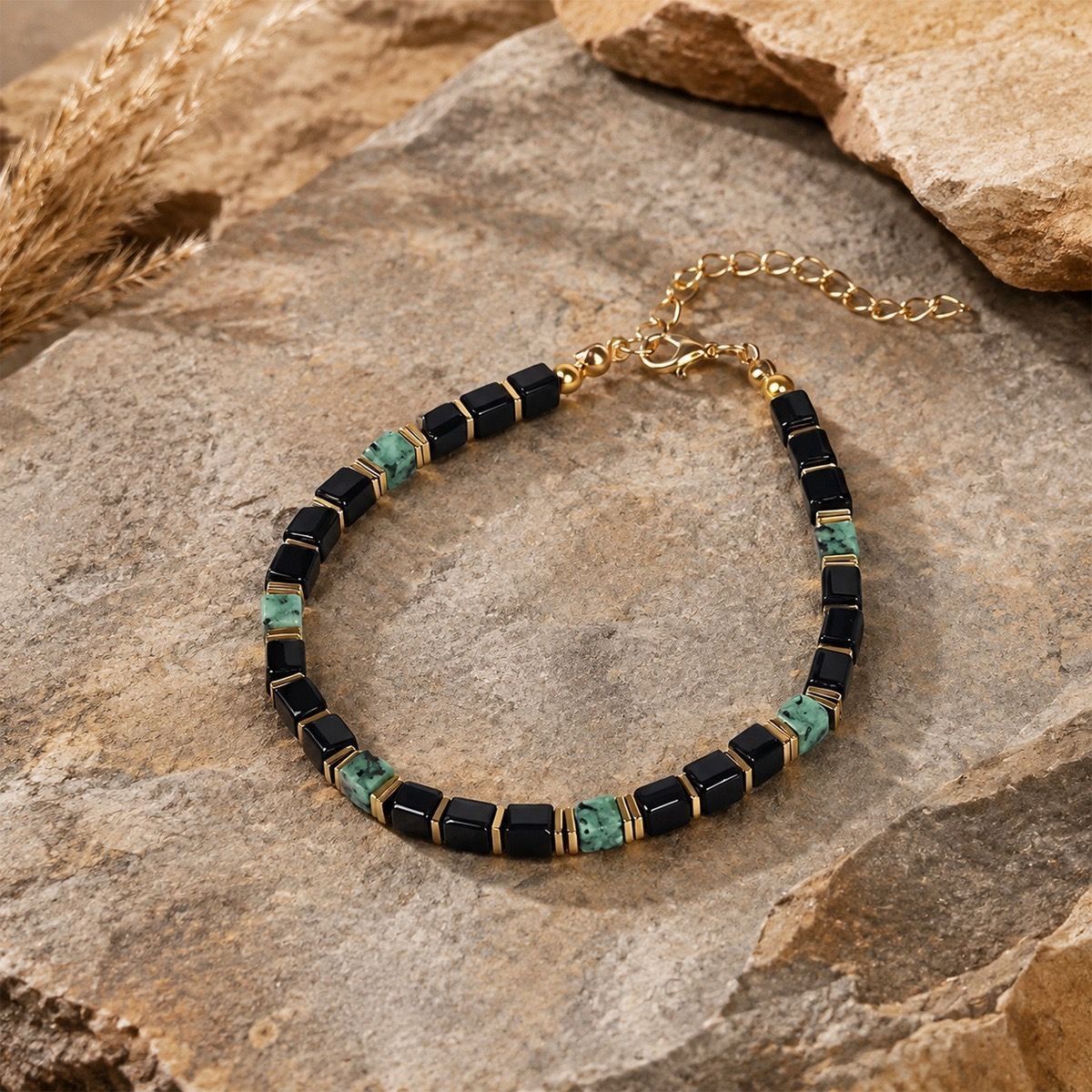 Detailed view of Obsidian Turquoise Bracelet on warm sandstone