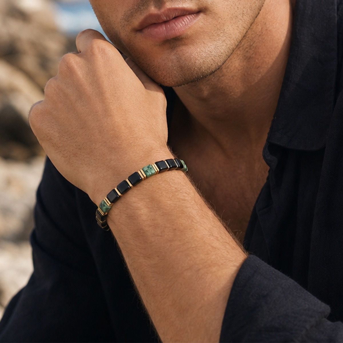 Man wearing geometric Obsidian Turquoise Bracelet with black t-shirt outdoors